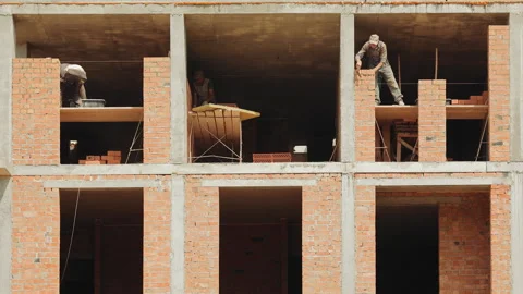 Construction Worker Adjusting Support Beam, A construction worker in a high Stock Footage 281182031