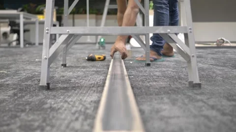 Construction worker aligning metal to partition foundation 스톡 동영상 296173298