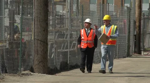 Construction worker and business man visiting construction site Stock Footage 10902681