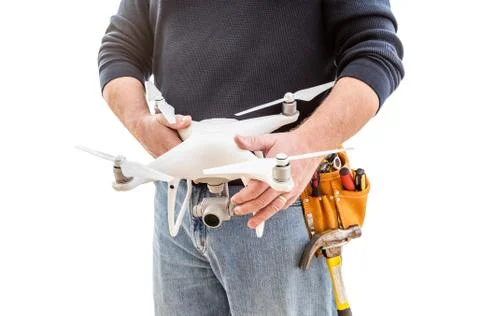 Construction Worker and Drone Pilot With Toolbelt Holding Drone Isolated on W Stock Photos