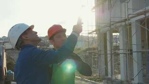 Construction worker and engineer talking at construction site site Stock Footage 83402068