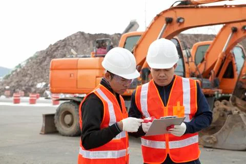 Construction worker and excavator Stock Photos