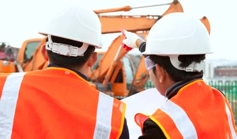 Construction worker and excavator Stock Photos