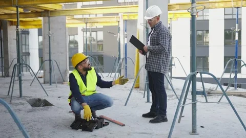 Construction worker and foreman discussing work plan on site Stock Footage 343449677