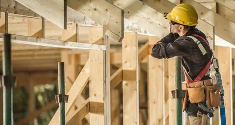 Construction Worker and Newly Built Wooden Roof Frame Stock Photos