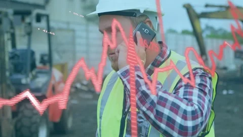 Construction worker answering phone alert, checking site data while red waveform Stock Footage 335317022