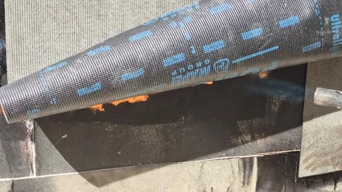 Construction Worker Applying Bituminous Waterproofing Membrane with Torch Stock Footage 336498440