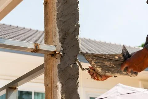Construction worker applying cement building site urban area action shot da.. Stock Photos