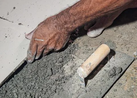 Construction Worker Applying Cement Mortar With Trowel During Building Work Stock Photos