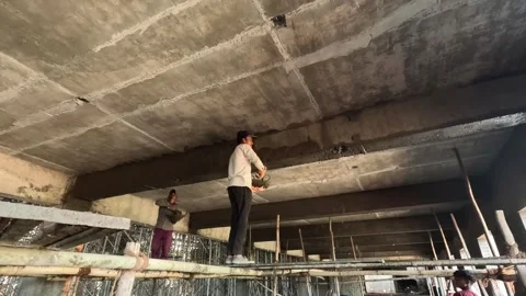 Construction Worker Applying Cement Plaster to Concrete Ceiling Structure on Stock Footage 340564289
