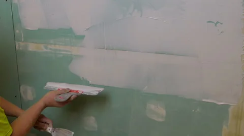 Construction Worker Applying Plaster on a Drywall Stock Footage 44230887