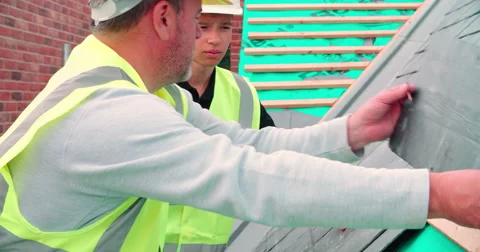 Construction Worker With Apprentice Laying Slate Tiles Stock Footage 56221795