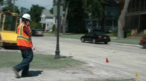 Construction Worker Approaching Street on Phone Video stock 12576477