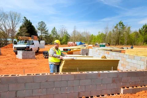 Construction worker arranging materials at job site in construction supervisor Stock Photos