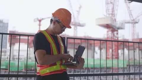 Construction worker Asian man using a Laptop to operate. Control workers Stock Footage 149494198