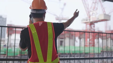 Construction worker Asian man using a smartphone to operate. Control workers Stock Footage 149494737