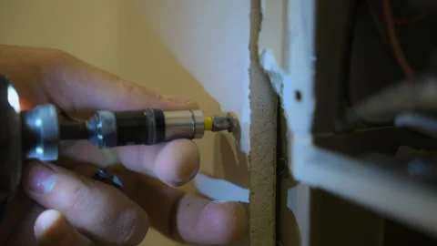 Construction worker assemble plasterboard and attach the drywall to metal frame Stock Footage 288280312