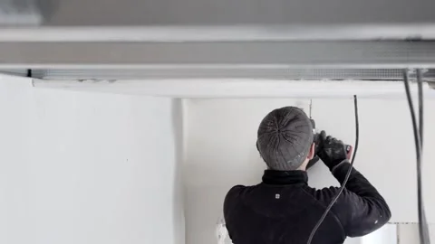 Construction worker assemble a suspended ceiling with drywall and fixing  Stock Footage 247316973