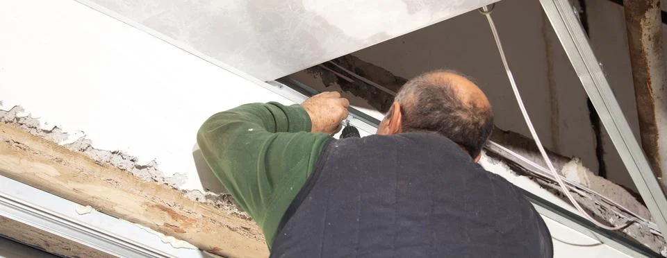 Construction worker assemble a suspended ceiling. Stock Photos