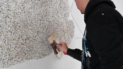 Construction worker assembles and patch plaster wall Stock Footage 168910689