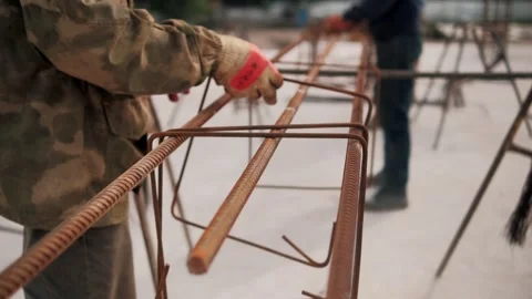 Construction worker assembling steel bars for reinforced concrete Stock Footage 292617534