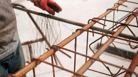Construction worker assembling steel cage for concrete reinforcement Stock Footage 292662102