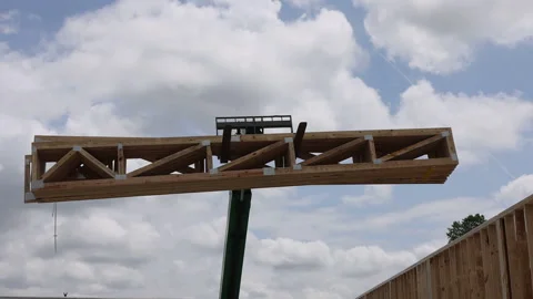 Construction worker assembling wooden framework use telehandler crane under Stock Footage 309312058