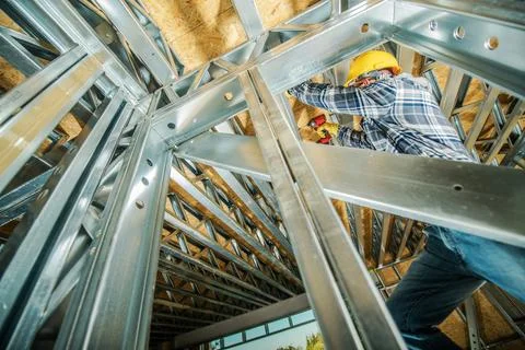 Construction Worker Attaching Metal Frame Elements 写真素材