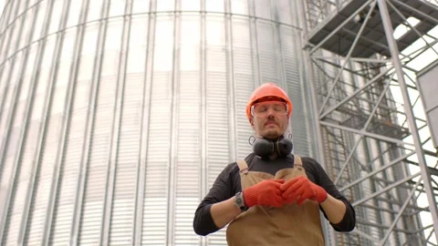 Construction worker on the background of a grain silo. Stock Footage 271630123