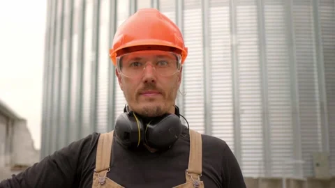 Construction worker on the background of a grain silo. Stock Footage 271630291