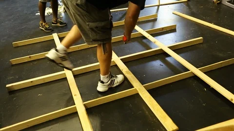 Construction worker banging a wooden frame with a mallet building Stock Footage 125635287