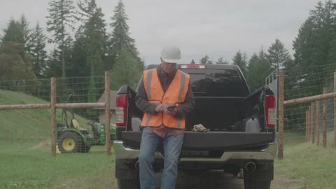 Construction Worker on Bed of Truck Texting Stock Footage 208803029