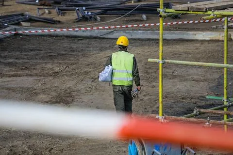 Construction worker from behind on construction site Stock Photos