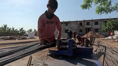 Construction Worker Bending Steel Rebar Rod Using Manual Tool on Building 動画素材 340505255