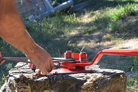 A construction worker bends a steel bar into a concrete structure Stock Photos