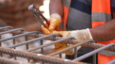 Construction Worker Binding Rebar for Concrete Column with Pliers and Gloves Stock Footage 311637771