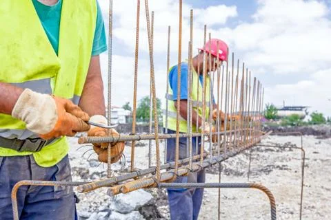 Construction worker binding rebar for reinforce concrete column at the buil.. Stock Photos