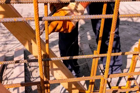 Construction worker binding rebar for reinforce concrete column at the buil.. Stock Photos