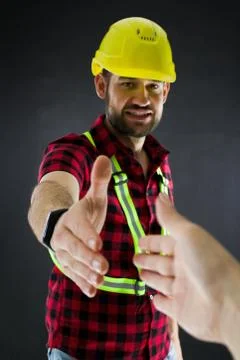 Construction Worker  on black background press the flesh. Stock Photos
