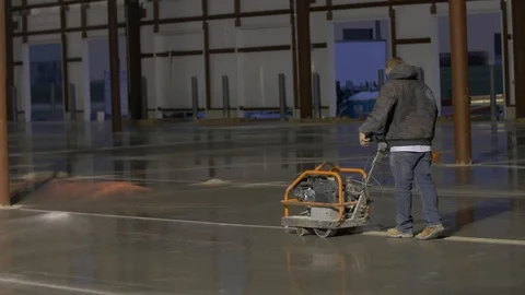Construction Worker in Black Coat Using Concrete Saw Stock Footage 101390329