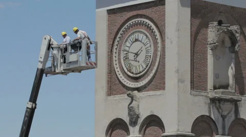 Construction worker on boom lift to work on the bell tower of a church - crane - Stockbeeldmateriaal 28949848