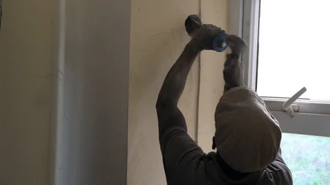 Construction worker breaking the wall with a chisel Stock Footage 117370148