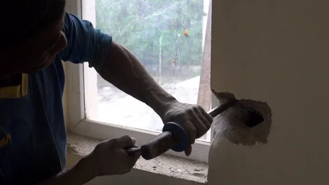 Construction worker breaking the wall with a chisel Stock Footage 117370154