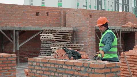 Construction worker building brick wall at outdoor site, Worker laying bricks Stock Footage 301280686