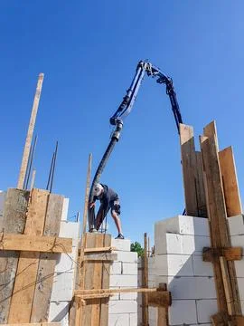 Construction Worker Building with Concrete Blocks and Pump Stock Photos