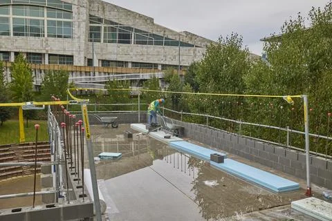 Construction worker building modern complex with scaffolding Stock Photos