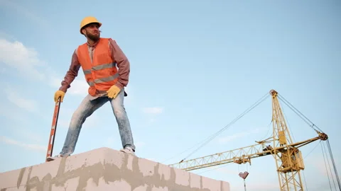 Construction worker on a building site directs activities from a high position Video stock 286051530