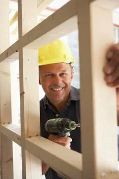 Construction Worker Building Timber Frame In New Home Stock Photos