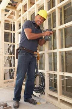 Construction Worker Building Timber Frame In New Home Fotos de archivo