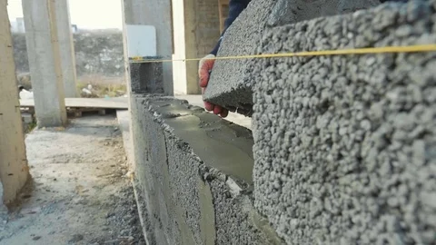 Construction worker builds brick wall, closeup view at construction site Stock Footage 83085541